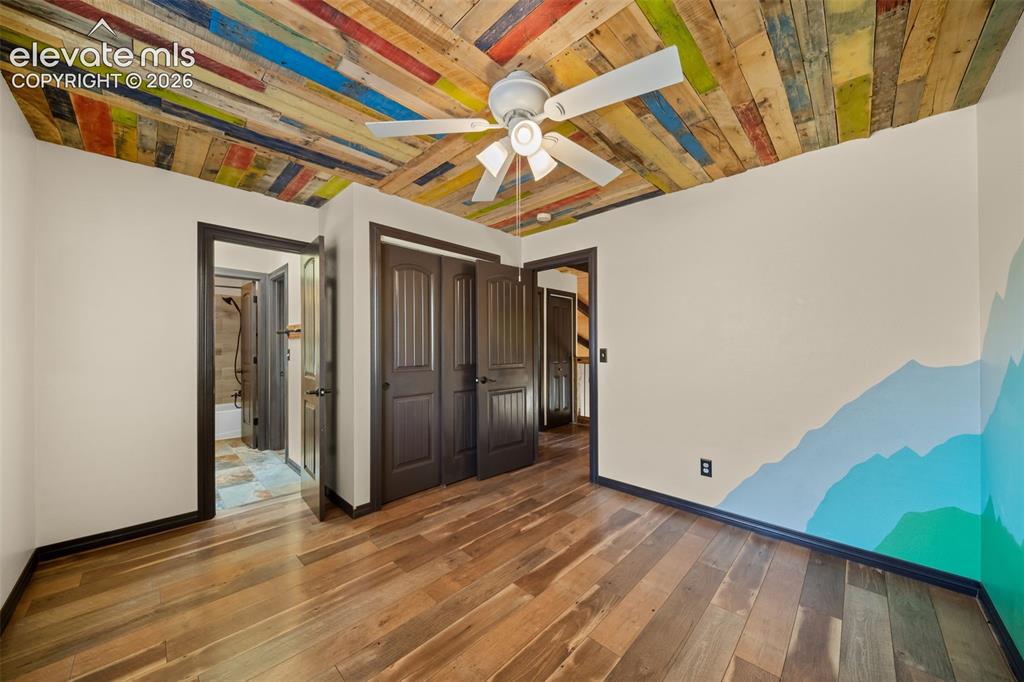 Image 24 of 48: Wood-finish flooring with a multi-colored wood plank ceiling