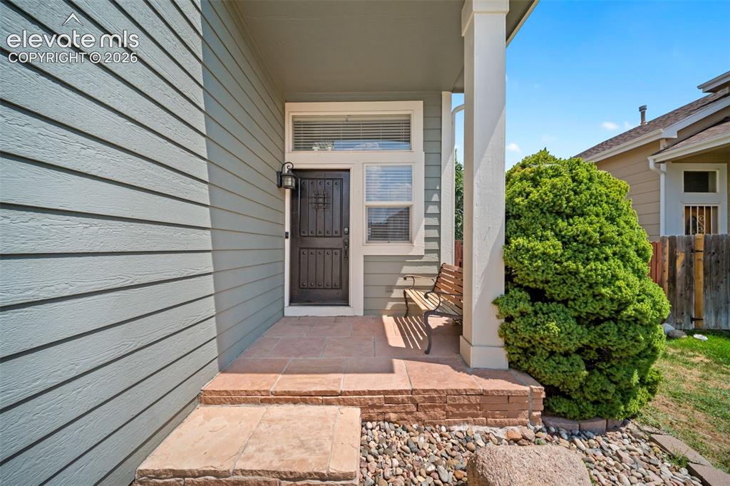 Image 3 of 48: Inviting front entry featuring horizontal siding, a covered porch with a su