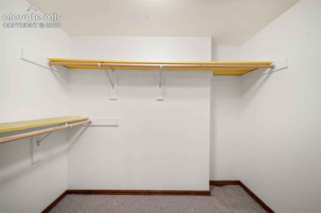 Image 33 of 48: Built-in shelving with hanging rods