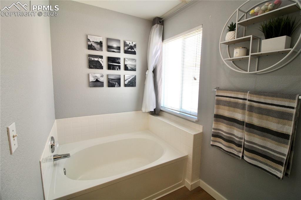 Image 20 of 50: Primary bathroom featuring double vanity and lofted ceiling