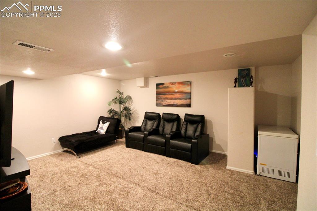 Image 34 of 50: Stairs with carpet flooring and recessed lighting