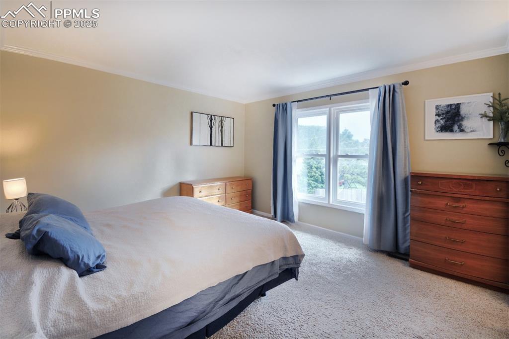 Image 11 of 32: Spacious Upper level primary bedroom has a adjoining bathroom.