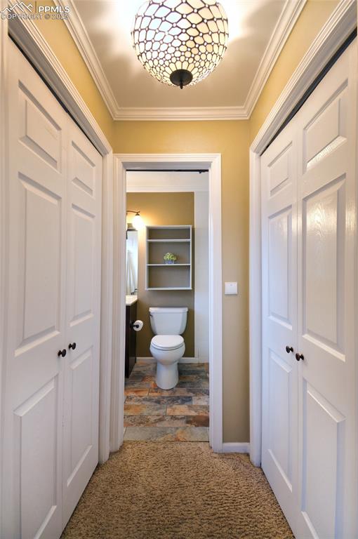 Image 13 of 32: Closets leading to the primary bathroom.