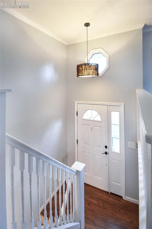 Image 2 of 32: Warm and welcoming front entry with hardwood floors.