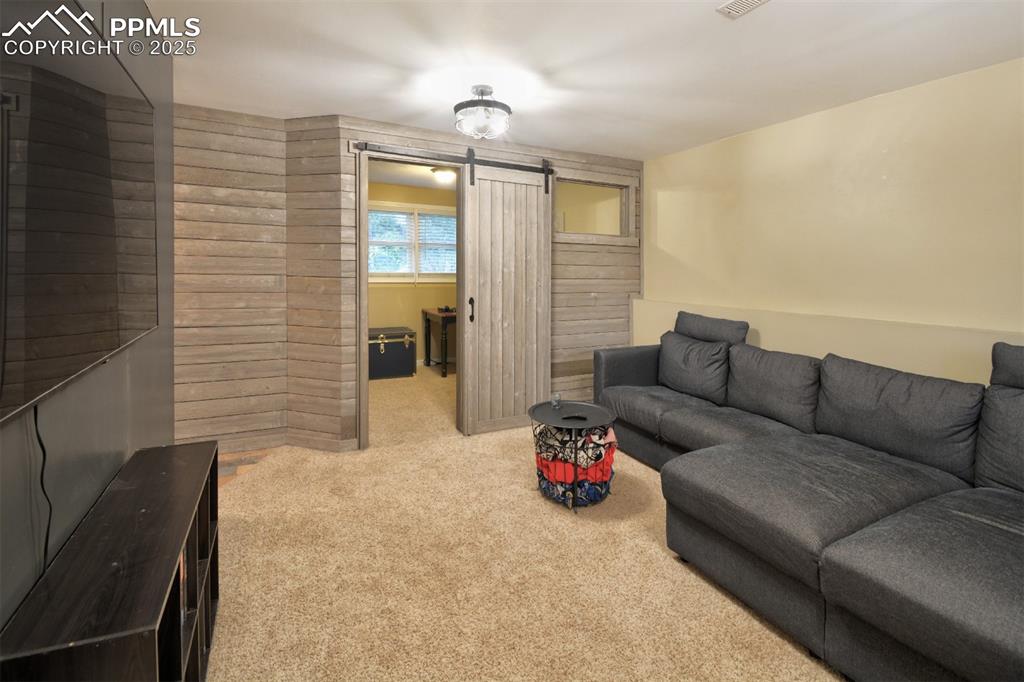 Image 20 of 32: Another view of the lower level family room looking into the lower level be