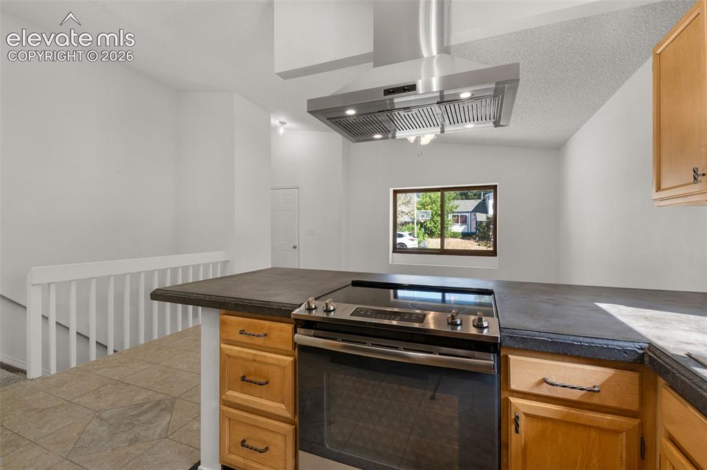 Image 11 of 36: Kitchen enjoys a vaulted ceiling