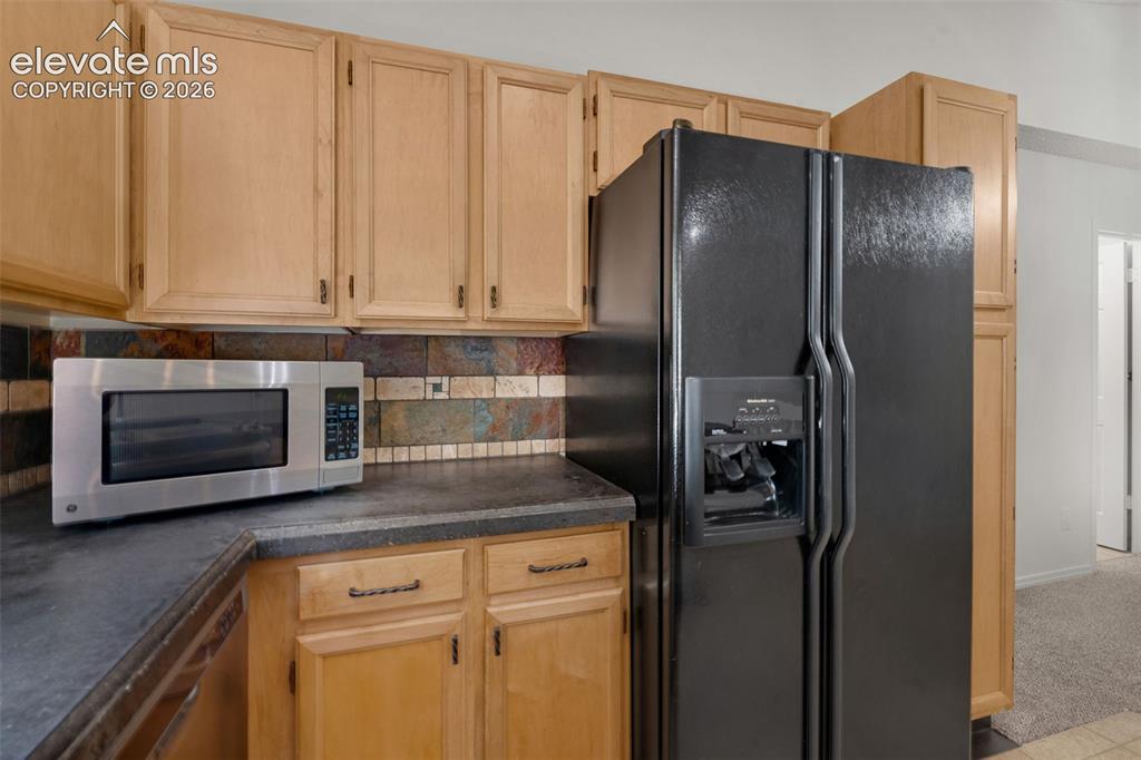 Image 12 of 36: Nice backsplash! All Kitchen appliances are included along with the washer