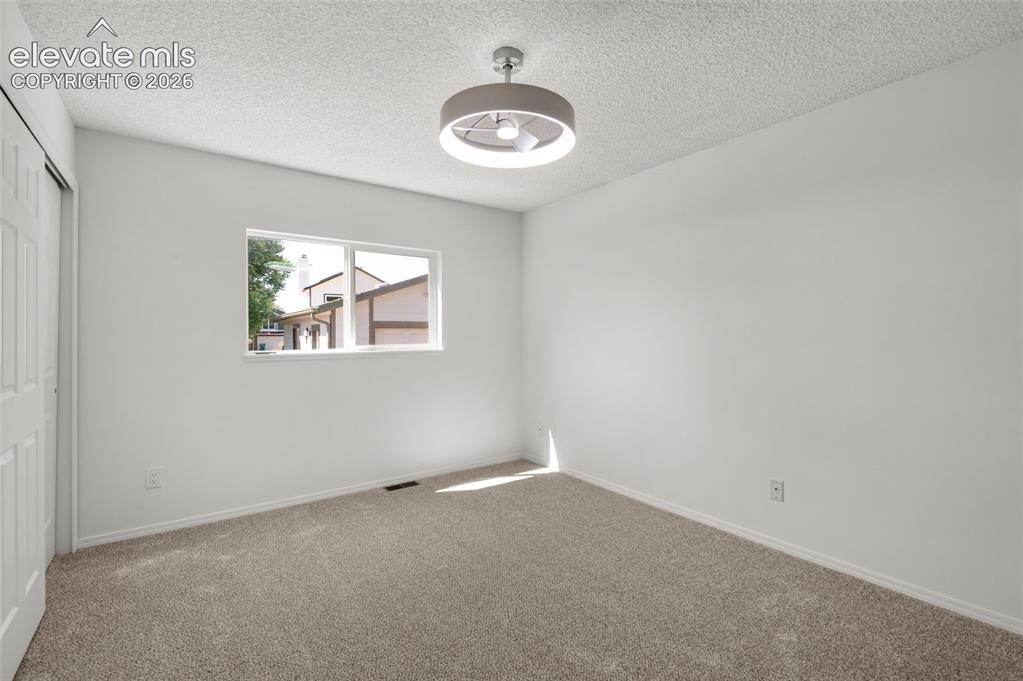 Image 14 of 36: Primary bedroom lights up with new light fixture that has a fan