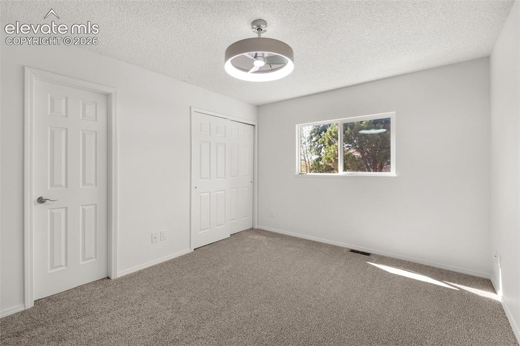 Image 15 of 36: Primary bedroom enjoys a private door to main level bathroom