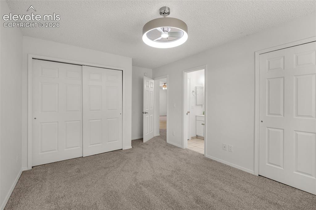 Image 16 of 36: Spacious closet at opposite end & you can see the private door to bathroom