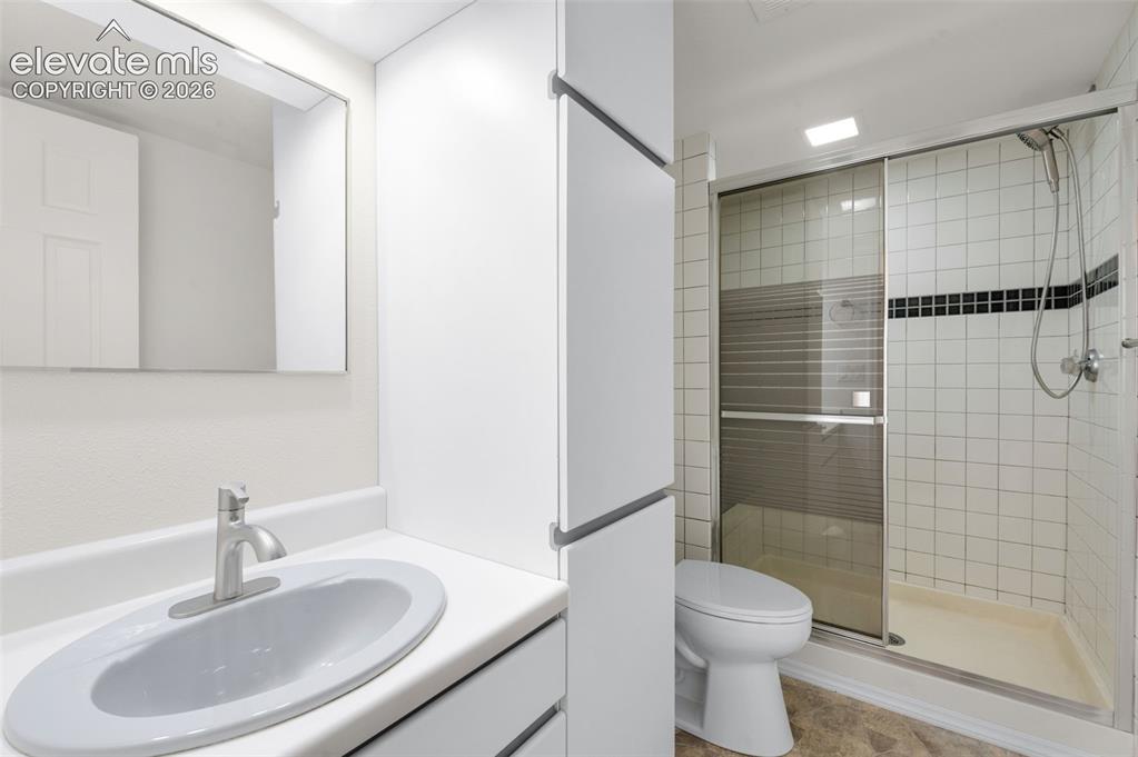 Image 28 of 36: Notice the nice tiled shower in this very clean bathroom