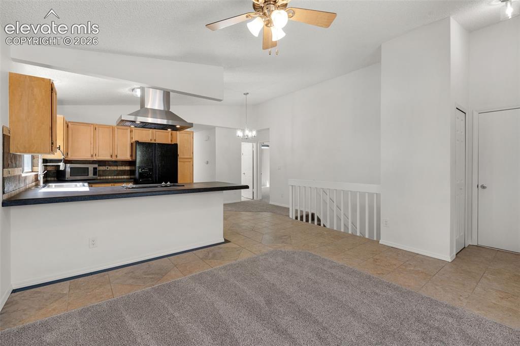 Image 8 of 36: Living room flows into kitchen