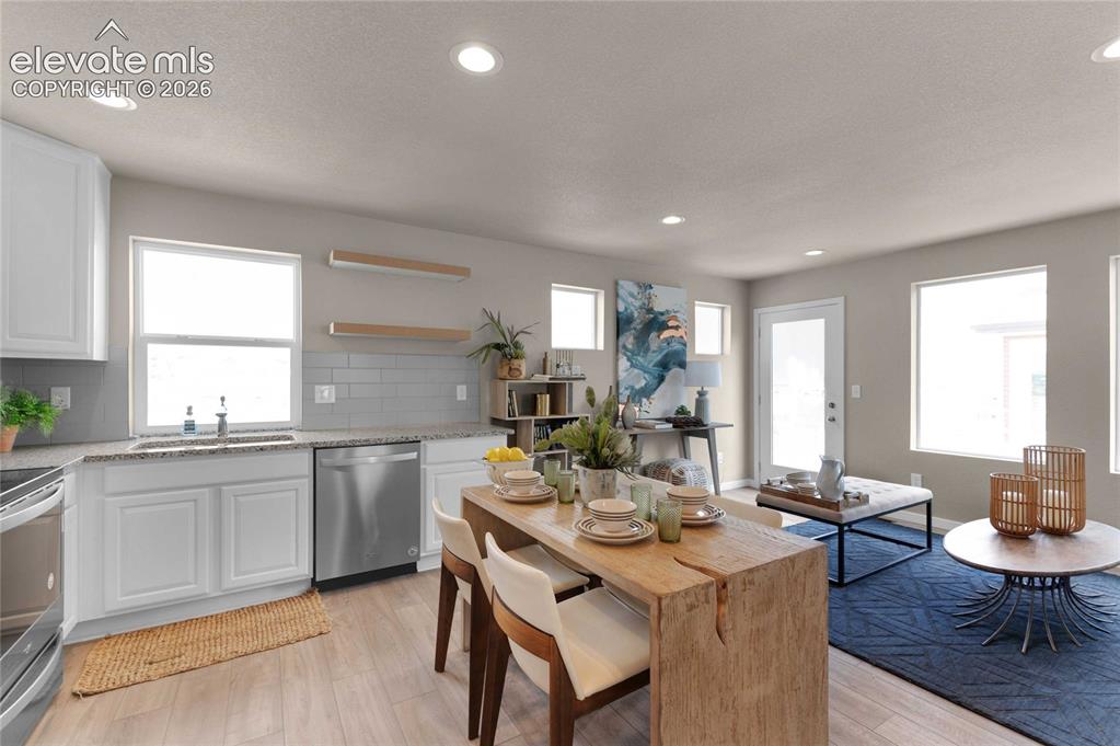 Image 12 of 31: Modern open-concept living space featuring light wood-finish flooring, rece