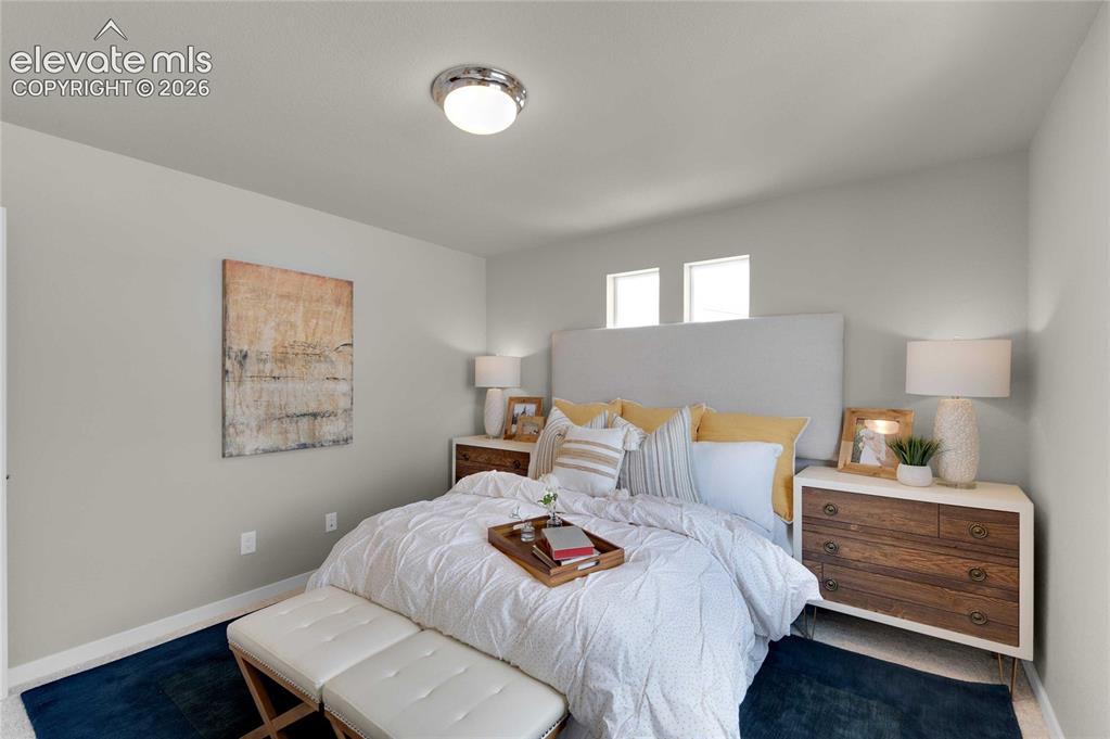 Image 16 of 31: Bedroom featuring neutral wall colors, two high-set windows, a flush-mount