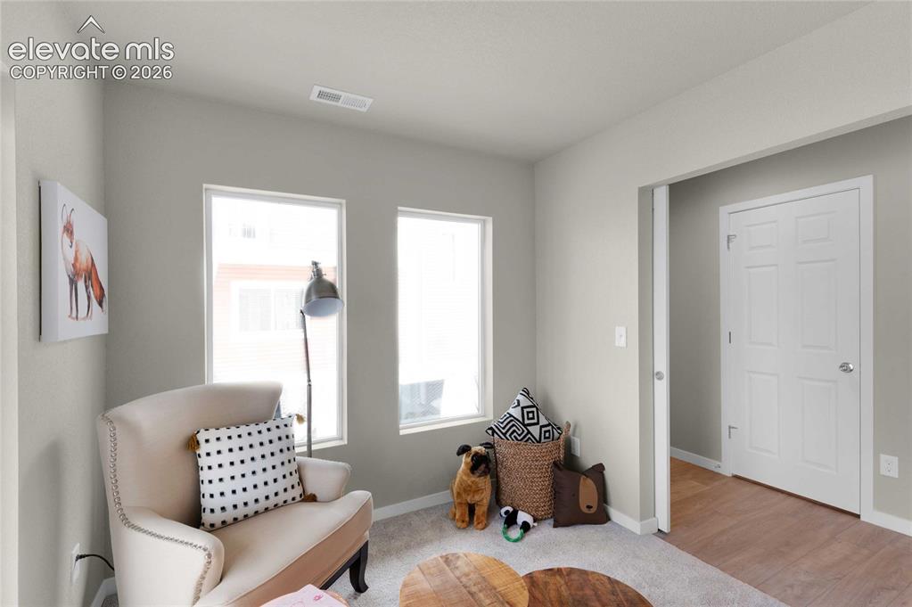 Image 2 of 31: Light gray walls complementing neutral-toned carpeting throughout the room