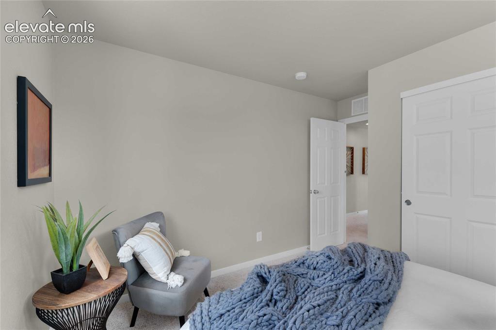 Image 21 of 31: Neutral-toned walls complement the light-colored carpet flooring