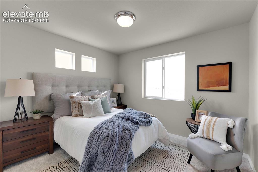 Image 22 of 31: Bedroom featuring three windows for ample natural light, a neutral color pa
