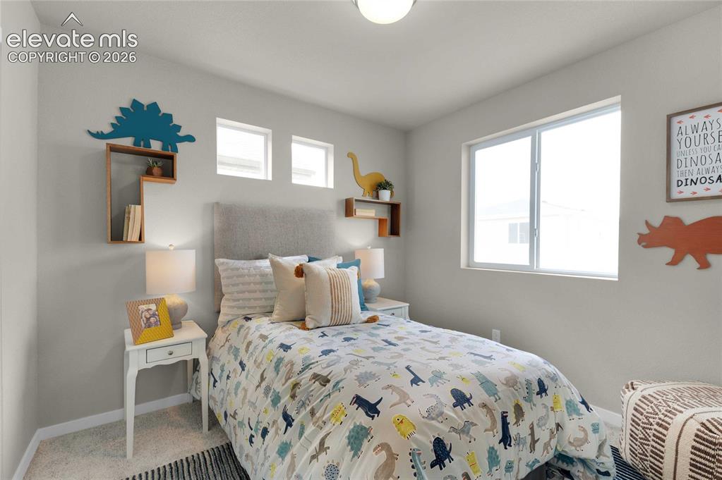Image 26 of 31: Bright bedroom featuring light gray walls, a built-in recessed window, and