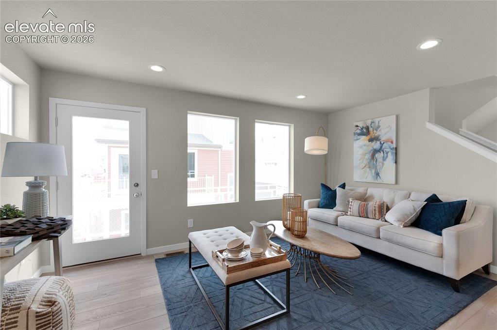 Image 9 of 31: Spacious living area featuring light wood-finish flooring, recessed lightin