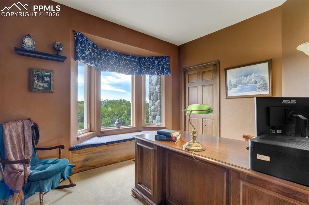 Image 19 of 40: Main level bedroom #2 overlooks the front garden and serves as a wonderful 