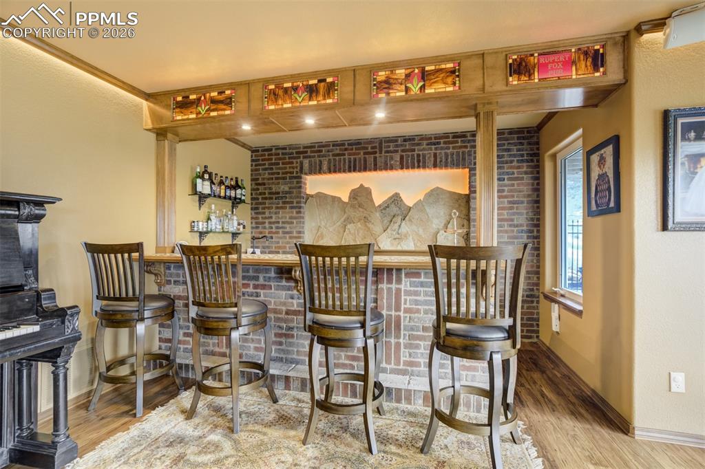 Image 7 of 40: Custom lower level bar   - perfect for entertaining in the fully landscaped