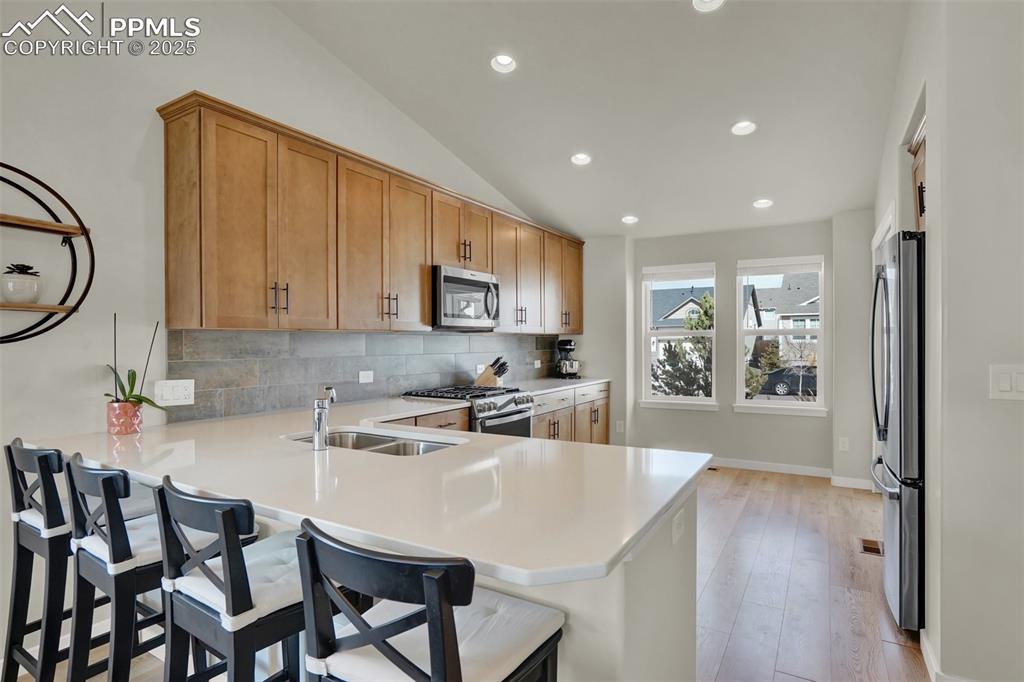 Image 17 of 42: Breakfast bar gives plenty of seating options whether your hosting a large