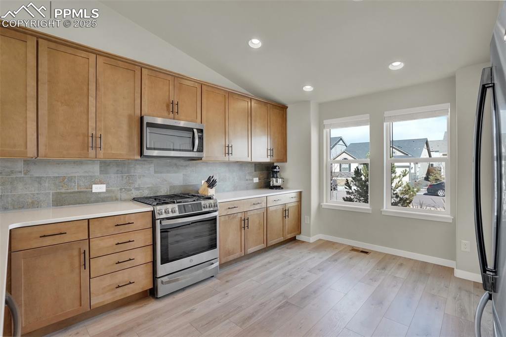Image 18 of 42: Gorgeous tile back splash to compliment the warm cozy but modern feel of th