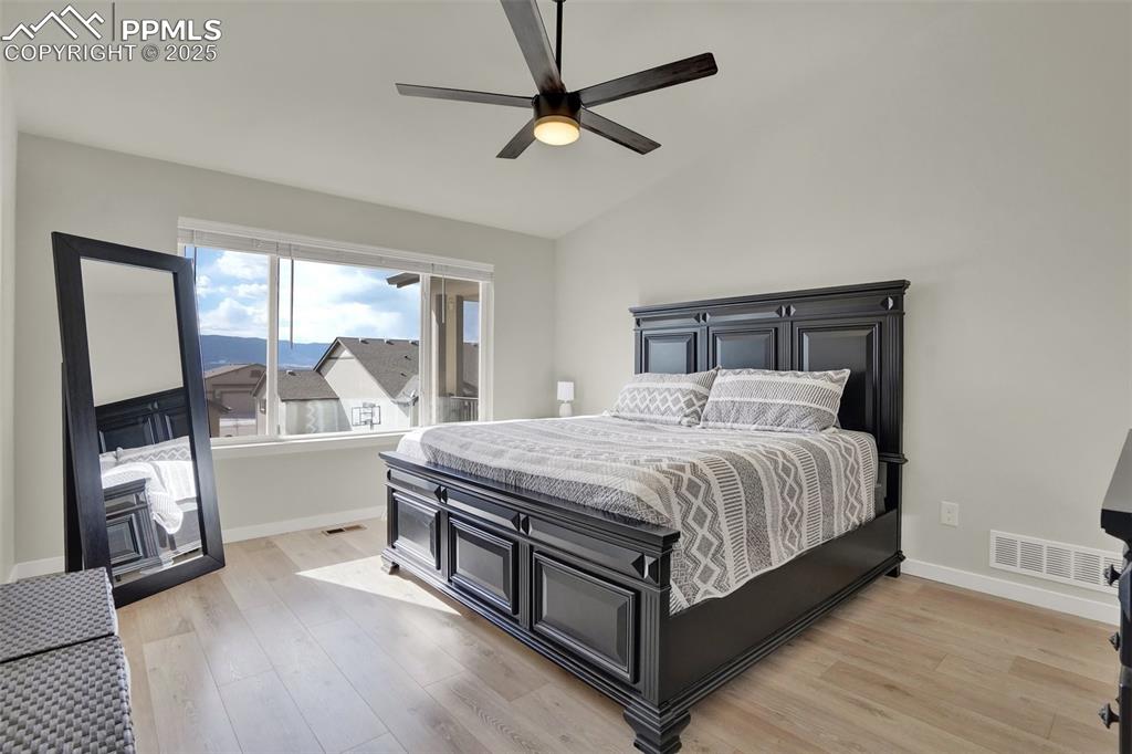 Image 19 of 42: Large and open main level primary suite with views of the mountains and vau