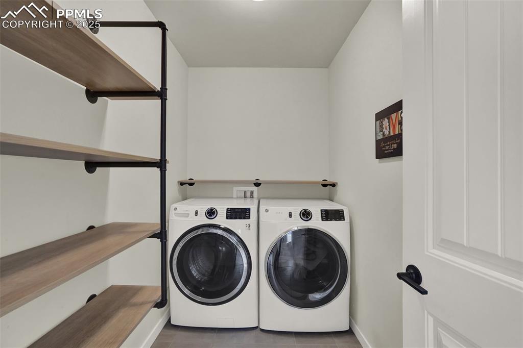 Image 27 of 42: Laundry area with shelving on main level