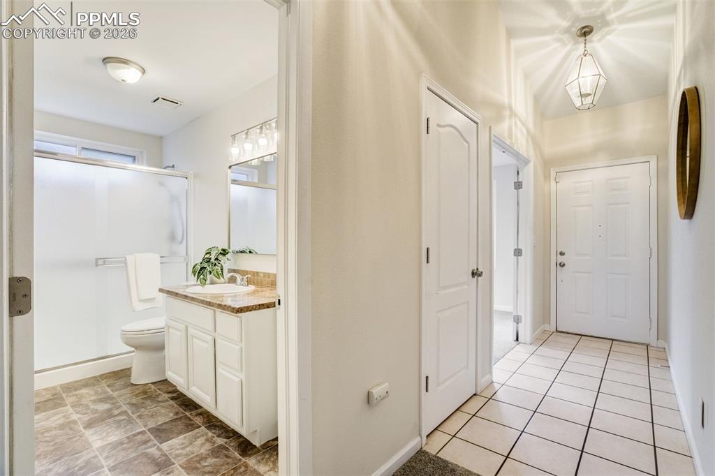 Image 10 of 43: Refreshed main level bathroom with oversized shower