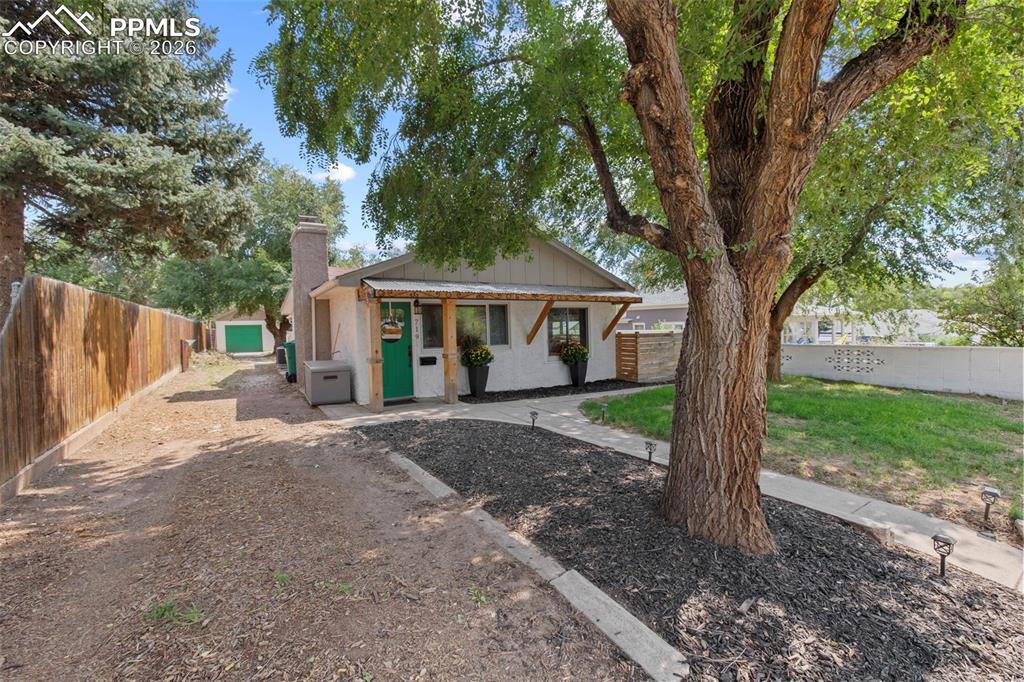 Image 23 of 26: Driveway and one car detached garage