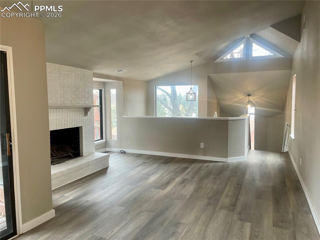 Image 13 of 43: Looking from Dining Area toward Great Room fireplace. All flooring new. Fre