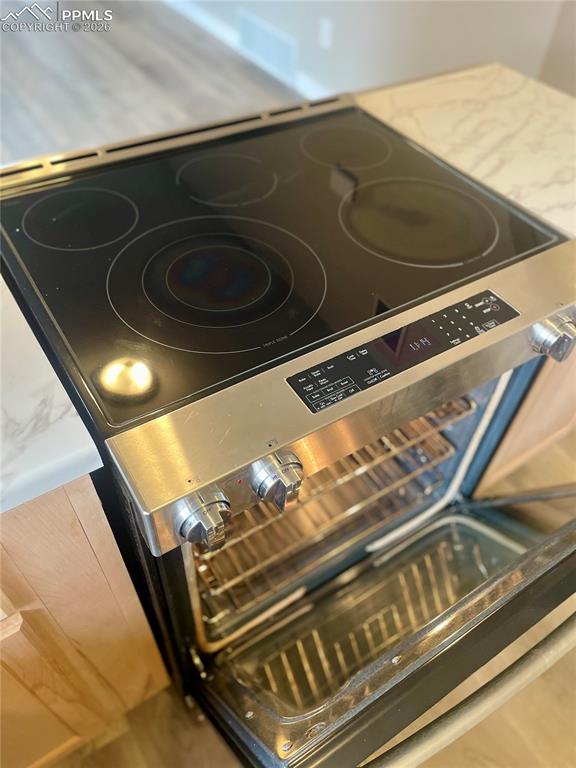 Image 23 of 43: Slide-in, stainless steel range/oven with 5-burner electric cooktop
