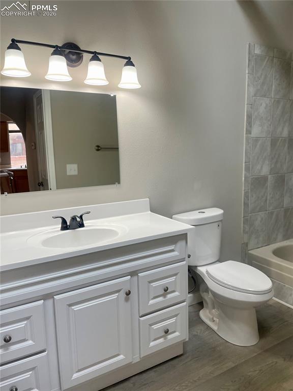 Image 31 of 43: Full bath with large vanity, LVP flooring, dual flush toilet & tub/shower c