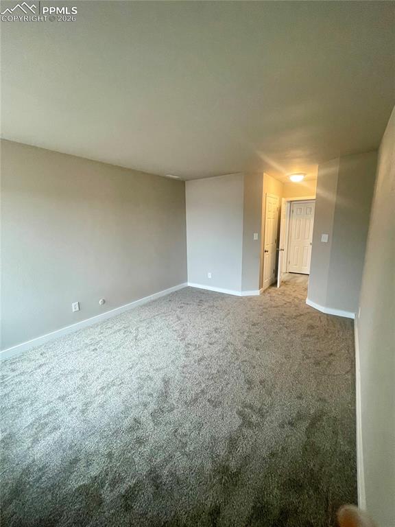 Image 37 of 43: Looking from back of bedroom toward closets and door to hallway.