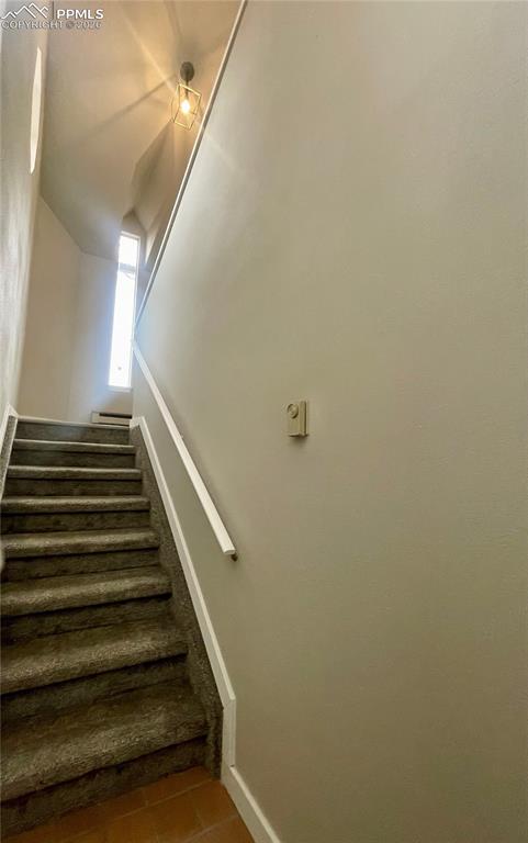 Image 4 of 43: Looking from tile entry up the stair toward the rest of the condo.