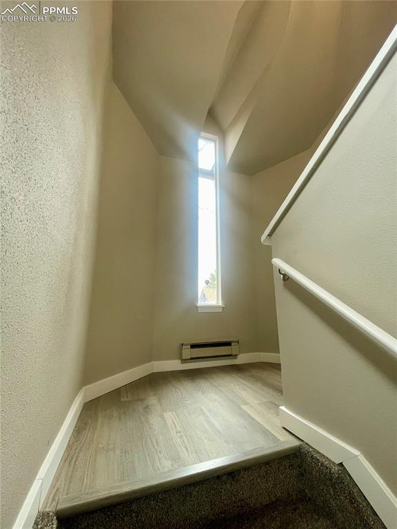 Image 5 of 43: Half-way up the stairs to large landing. LVP floor.