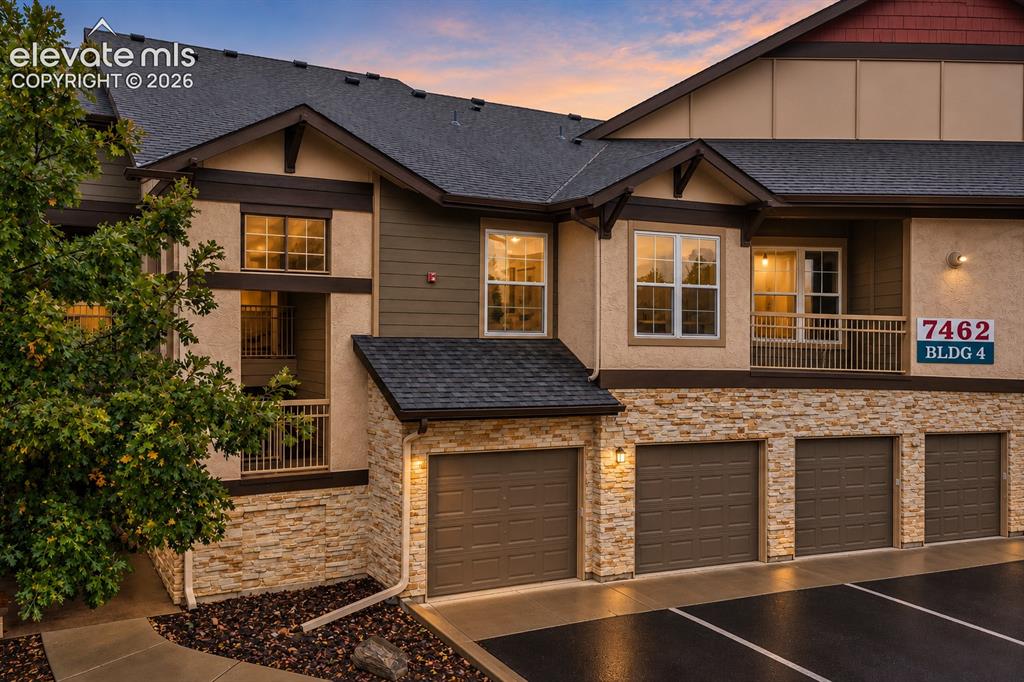 Caption: Exterior facade featuring stacked stone veneer, horizontal siding, multi-gabled rooflines, integrate