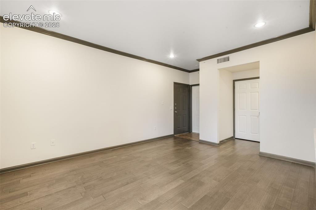 Image 13 of 50: Interior space featuring wood-finish flooring, recessed lighting, and paint