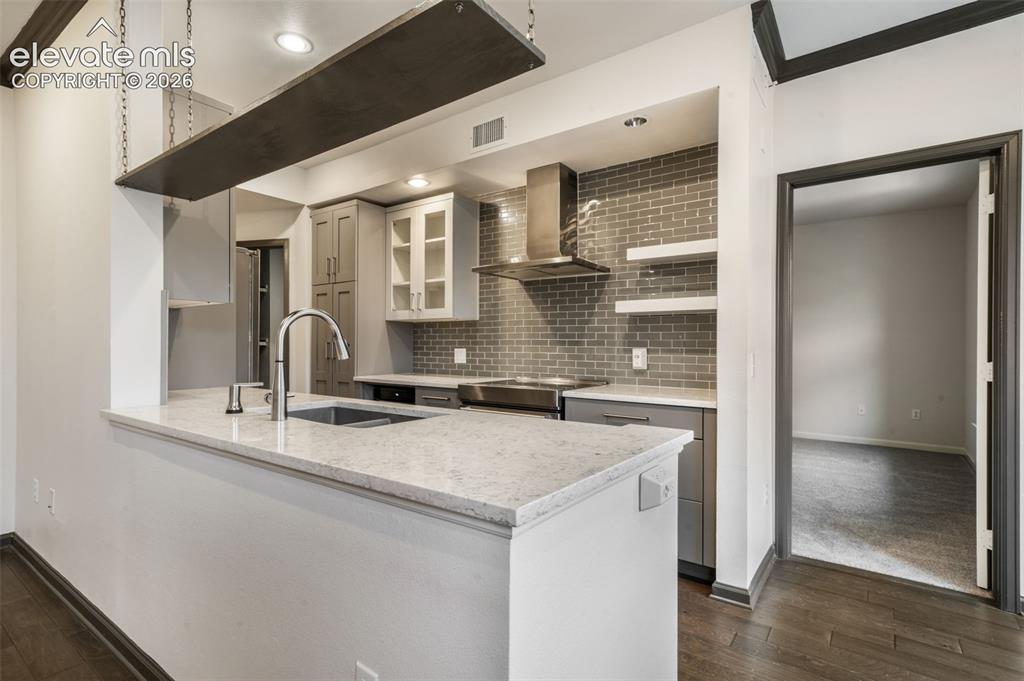 Image 14 of 50: Kitchen featuring quartz countertops, subway tile backsplash, stainless ste