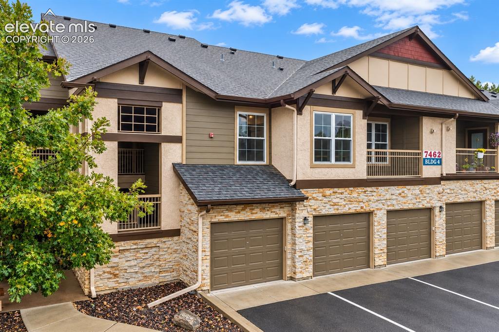 Image 3 of 50: Exterior facade featuring stone veneer siding, horizontal lap siding, multi