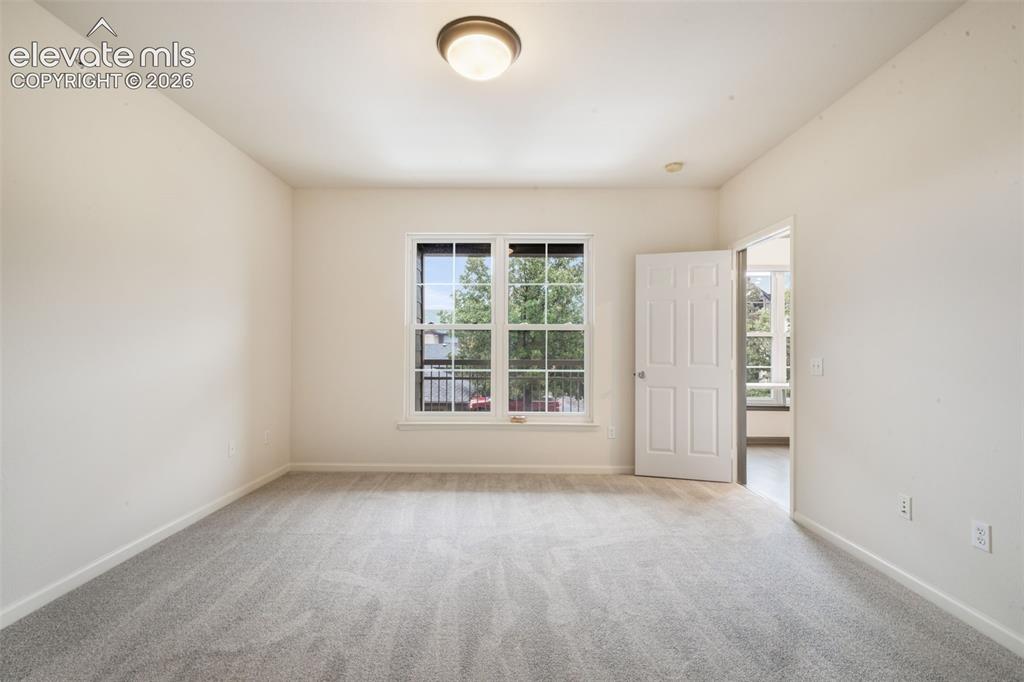 Image 30 of 50: Interior space featuring neutral wall tones, carpeted flooring, a six-panel