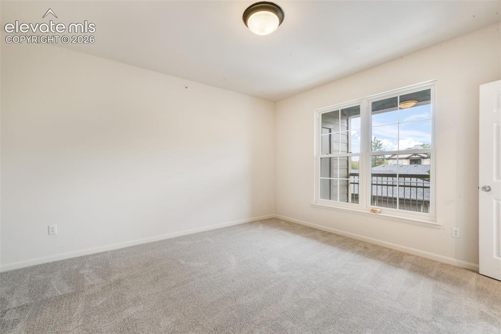Image 33 of 50: Neutral interior featuring wall-to-wall carpeting, a multi-pane window, flu
