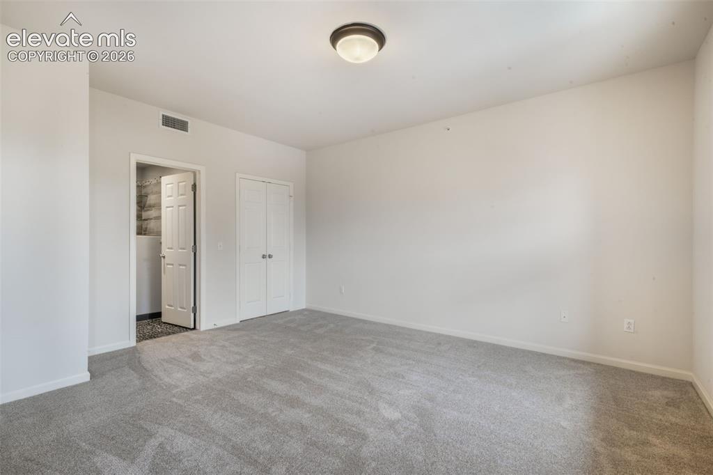 Image 34 of 50: Neutral interior space featuring wall-to-wall carpeting, a flush-mount ceil