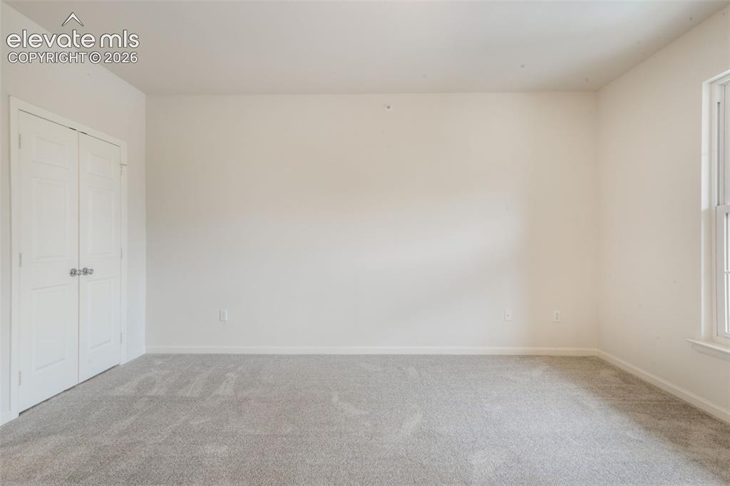 Image 38 of 50: Neutral interior space featuring neutral wall-to-wall carpeting, double-pan