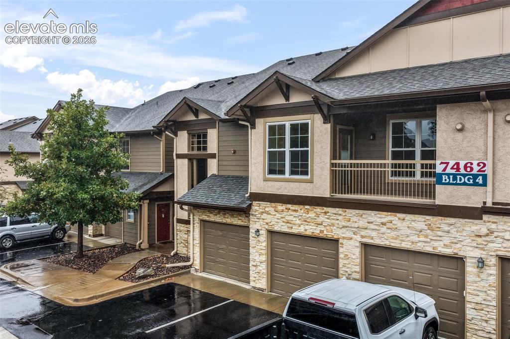 Image 43 of 50: Multi-story exterior featuring a stone veneer facade, horizontal siding, as