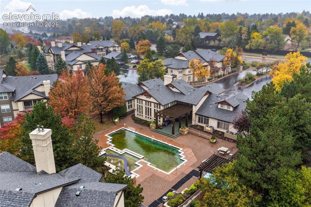 Image 44 of 50: Aerial perspective of a community featuring an outdoor swimming pool, integ