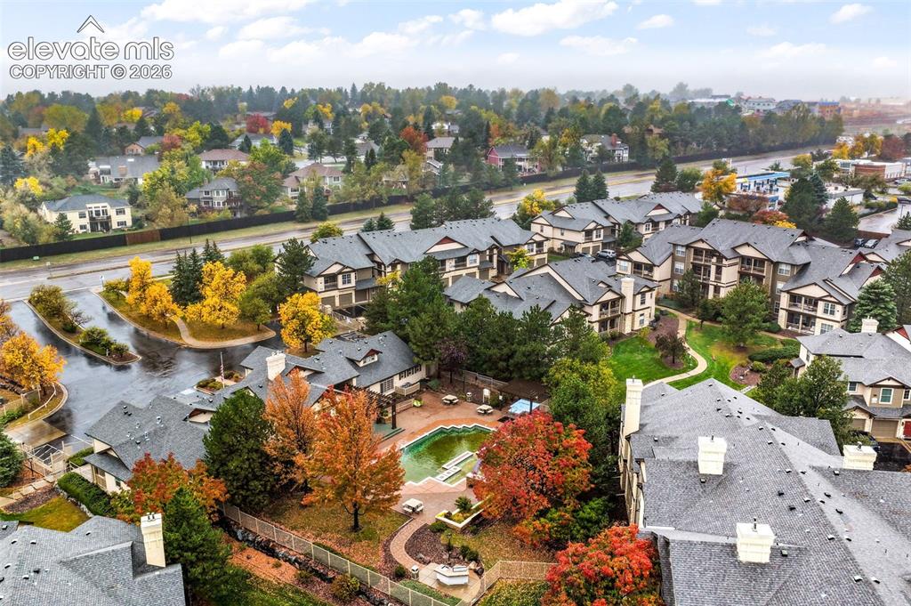 Image 47 of 50: Aerial perspective of a multi-unit complex featuring an outdoor swimming po
