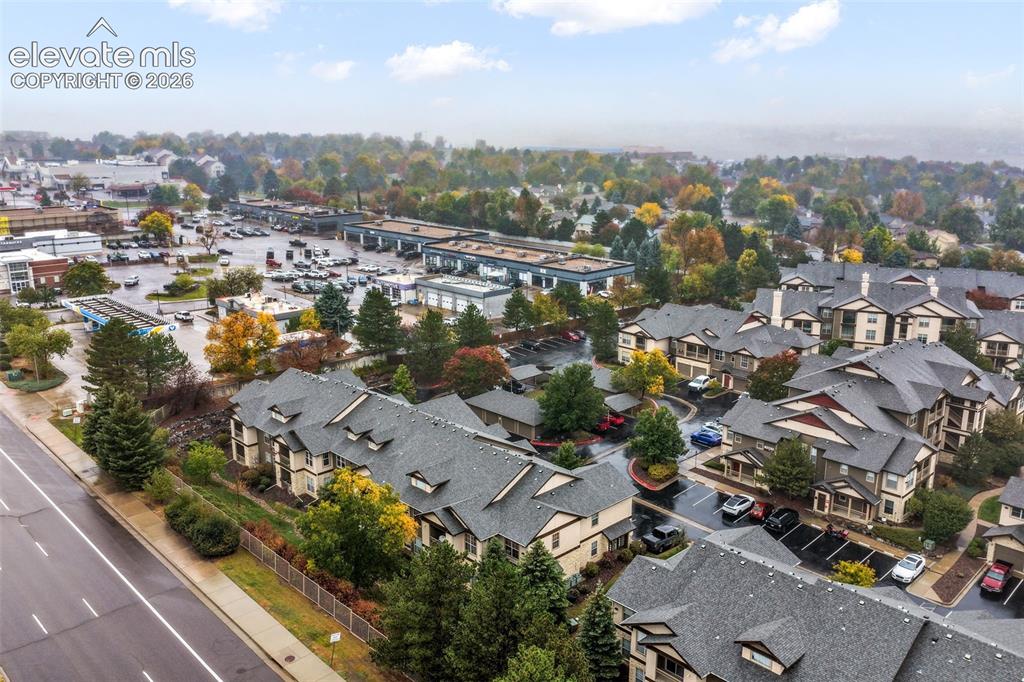 Image 48 of 50: Multi-unit residential complex featuring gabled shingle roofing, exterior s