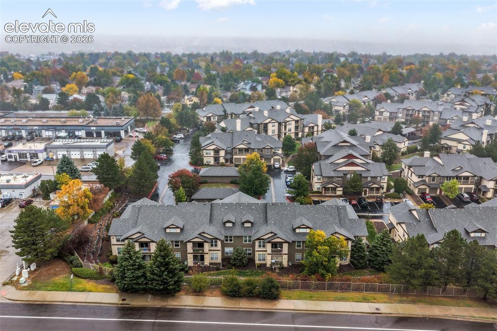 Image 49 of 50: Aerial perspective of a multi-unit residential complex featuring gabled roo